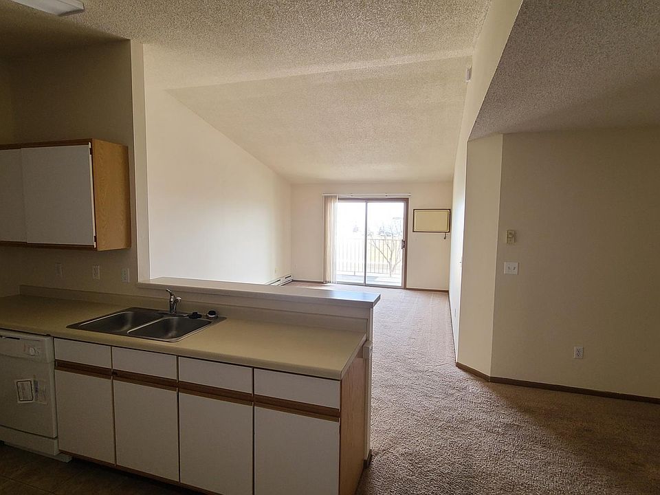 Kitchen + dining room, living room with balcony looking toward the east, and a bedroom just off to the right.