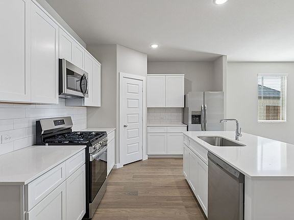 Kitchen in the Holden home plan by Trophy Signature Homes - REPRESENTATIVE PHOTO