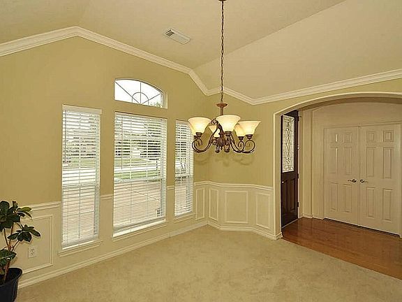 Dining room complete with Wainscot, chandelier & chair rail throughout.