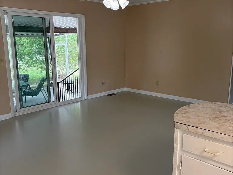 Dining area and sliding glass door entrance to screened in patio