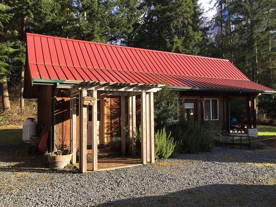 Smaller cottage has laundry room, storage, bathroom, studio, kitchenette and patio.