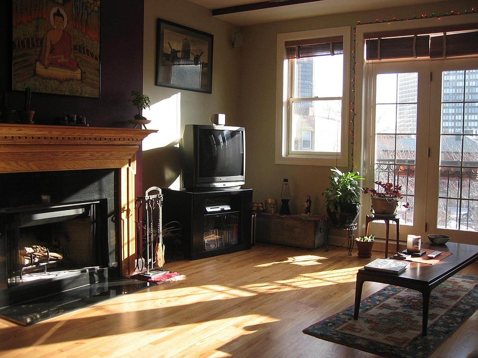 Living room with eastern exposure overlooking beautiful tree-lined street