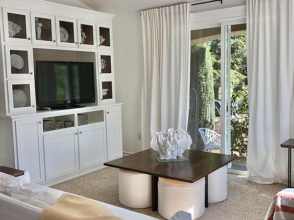 Living room with smart TV, large slider doors to east patio.