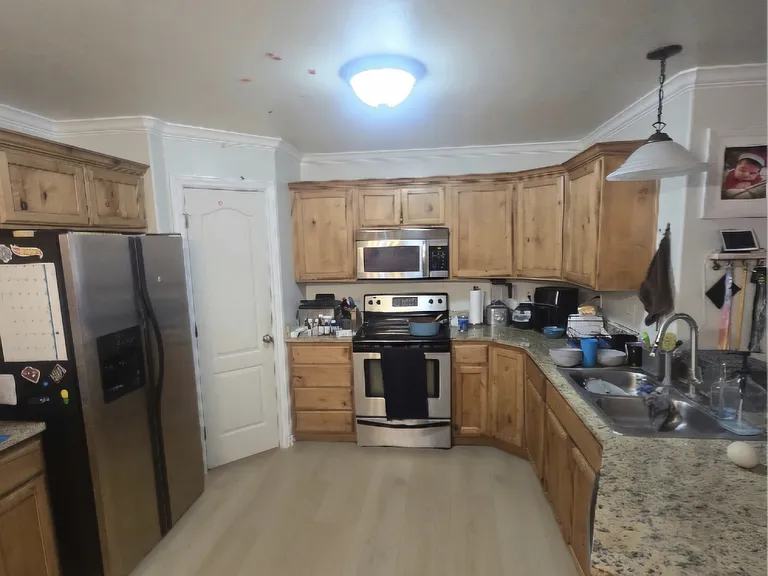 This is the condo's kitchen, with amble cabinet and storage space and a generous pantry, and the brand new flooring.