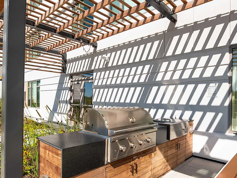 Fire up the flavor at Eleven33's outdoor grilling stations complete with modern stainless steel setups and shaded seating for easy summer get-togethers.