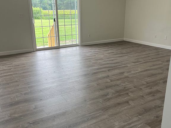 Great room view with 6 foot ceiling fan & brand new maintenance free waterproof flooring