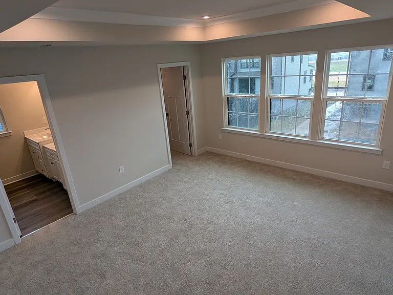 owner's suite bedroom with vaulted ceiling