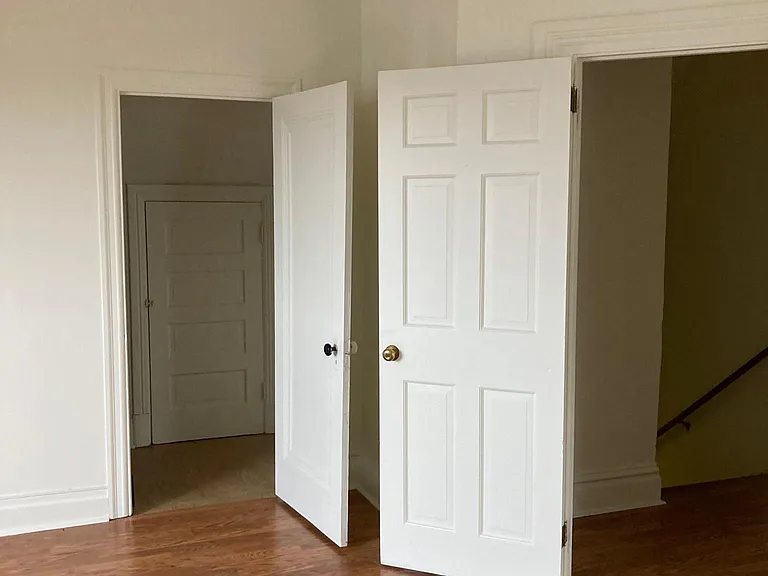 Entrance to living room from hallway with one of the closet/storage areas in the living room.