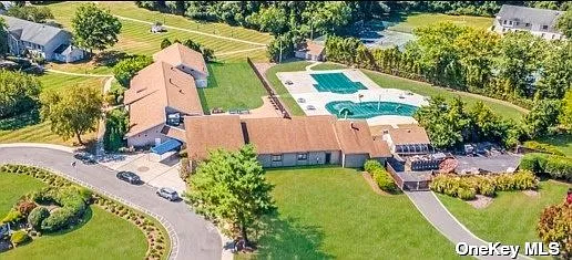 Close proximity to clubhouse, pool, tennis, bbq patio area, etc. (building top left of photo)