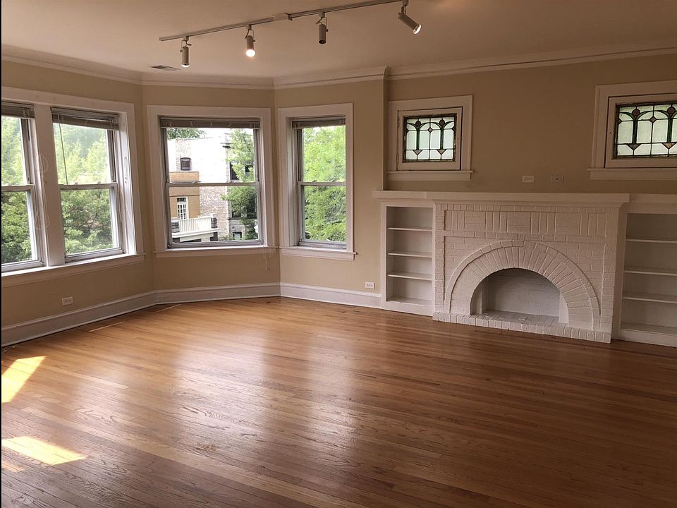 Beautiful Living Room with Built In Shelving Decorative Fireplace and Track Lighting