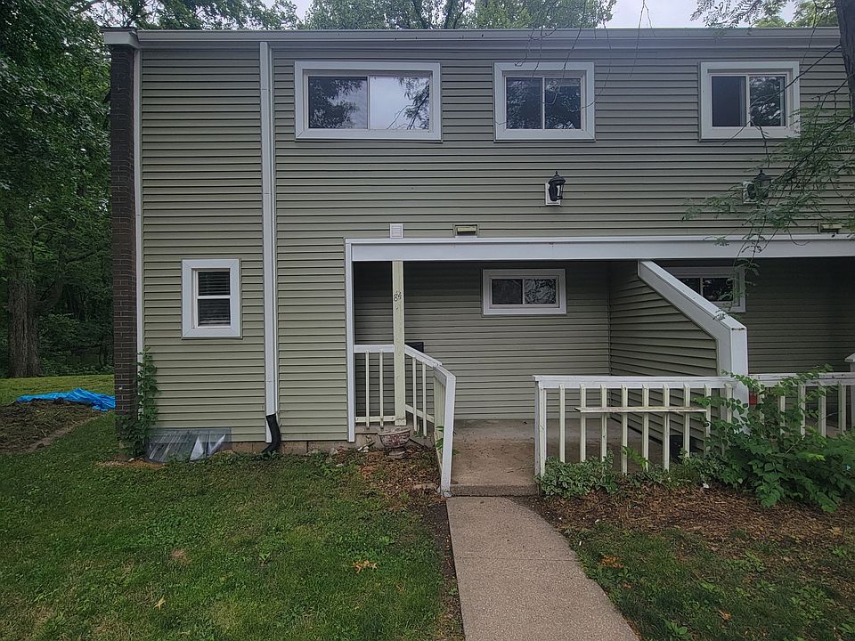 The front of the property includes a small concrete patio. This is an end unit.