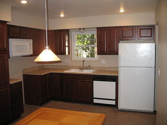 Large remodeled kitchen with cherry cabinets, pantry, desk & huge eating area!