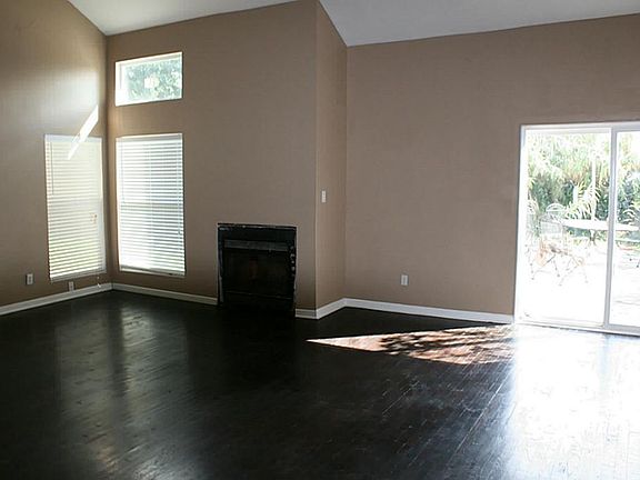 Huge living room with fireplace and extra high ceilings.