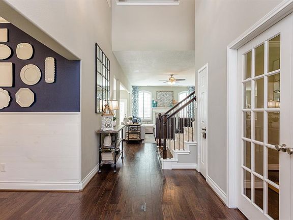 The light and bright entry with soaring ceiling welcomes you in to this fabulous home. Beautiful builder details and designer touches are apparent throughout and the gorgeous hardwood flooring runs through the entire first floor.