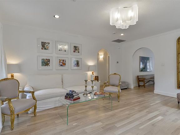 Living room has designer Country White Oak hardwood floors, recessed lighting and a designer pendant light fixture.  Home has a great flow as living room leads into the kitchen and dining area.