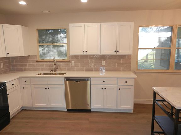 remodeled kitchen with new cabinets, appliances and quartz countertops