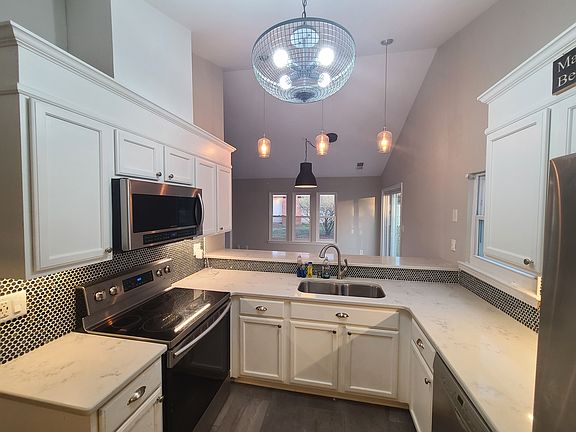 Beautifully upgraded kitchen with added bar ledge facing dining area