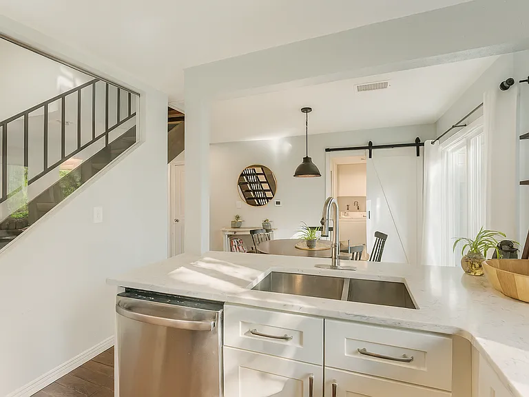 A peek from the kitchen reveals the open-concept dining area, all drenched in natural light_perfect for entertaining or cozy nights in.