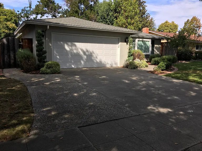 Large wide driveway easily fits two big SUVs.