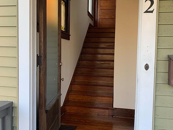 Entry hall to apartment 2 with new period lighting and stained glass window.