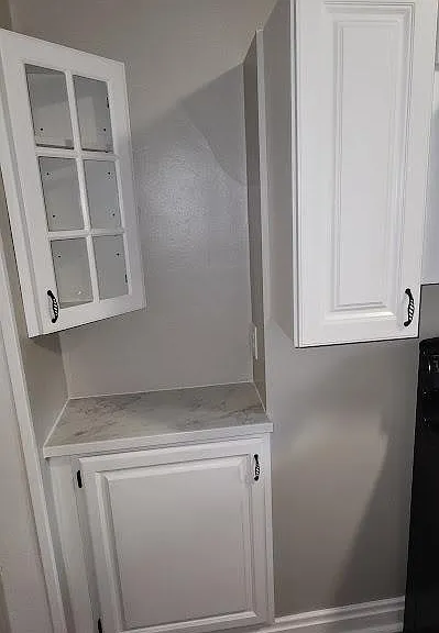 New kitchen cabinets with small nook with outlet & new , countertop, glass cabinet