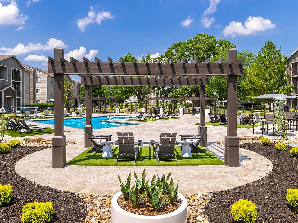 Discover the serene poolside retreat at where modern pergolas and cozy seating areas provide the perfect setting for relaxation. Surrounded by lush landscaping and beautiful architecture, this oasis invites you to unwind and enjoy the outdoors.