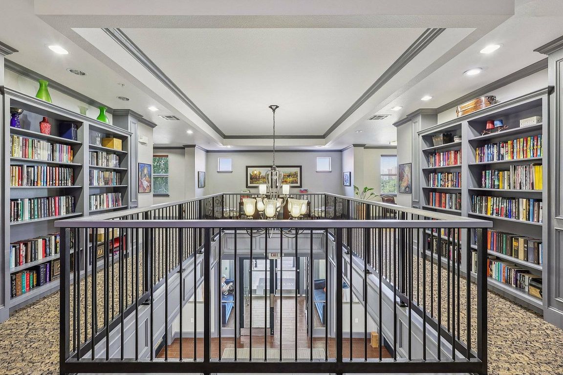 Residents enjoy the cozy library at McDermott 55 in Plano, perfect for reading or working.