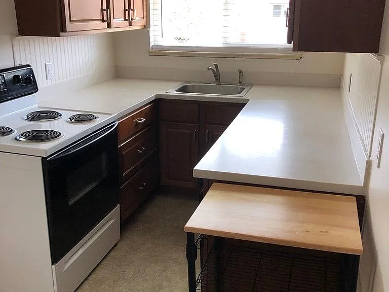 Ample cabinet space, bright kitchen.