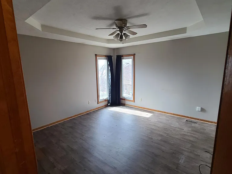 Primary bedroom with 2 corner windows and walk in closet.
