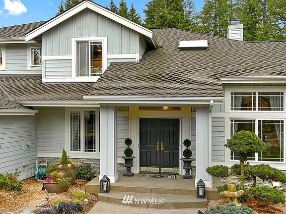 A newer concrete walkway leads to the front entry, a side load 3 car garage with custom built-ins.