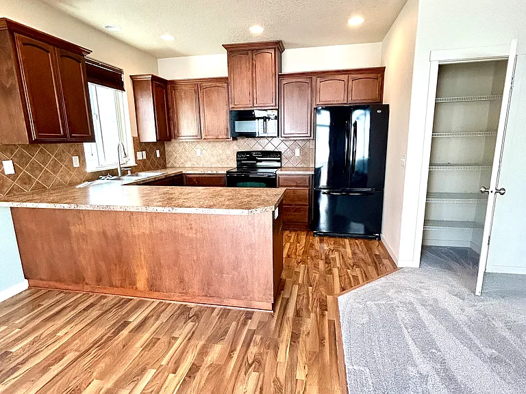 Kitchen with peninsula with room for stools; pantry