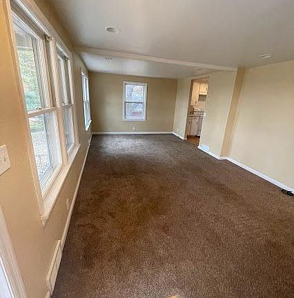 Carpeted family room with lots of natural light.