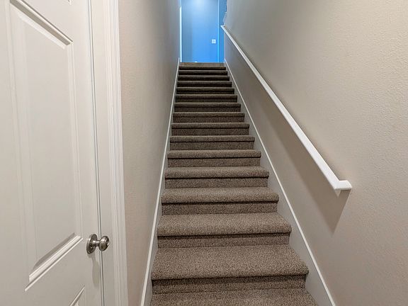 Stairs leading up to second floor condo