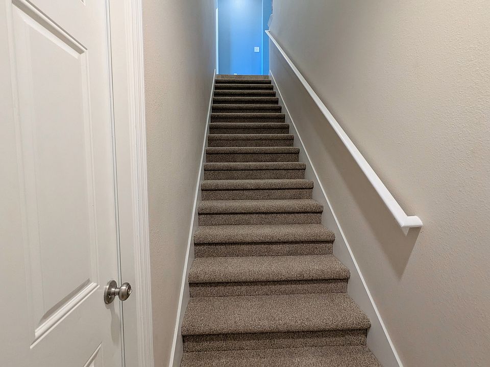 Stairs leading up to second floor condo