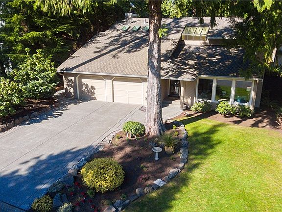 New driveway, composition roof w/ big skylights, nice landscaping front & back, Big 2 car garage