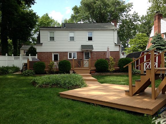 Back of the house. Entry to garage from deck.