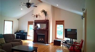 Great room with gas fireplace.  Antique mantel from a 1900's house.  Hickory floors.
