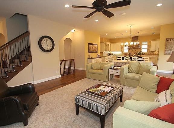 Open plan Family Room and Kitchen, 10 ft ceilings and iron-wrought staircase leading to upstairs as well as basement.