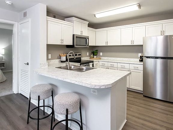 Indulge open living in this stunning kitchen oasis boasting ample cabinetry and a versatile breakfast bar overlooking the living area for the ultimate in convenience and style.