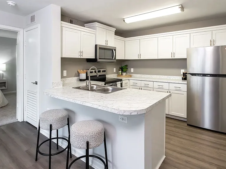 Indulge open living in this stunning kitchen oasis boasting ample cabinetry and a versatile breakfast bar overlooking the living area for the ultimate in convenience and style.