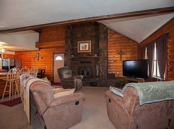 Living room has beautiful stacked stone fireplace