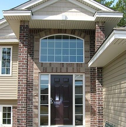 Elegant front entry showing detail of brick and shakes
