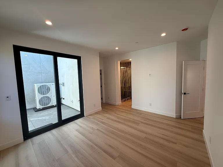 Large master bedroom with private patio and walk-in closet