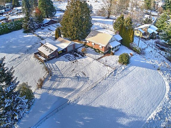 You'll enjoy fenced pasture areas surrounding the property. Behind the farmhouse you'll see a fenced garden area and barn.