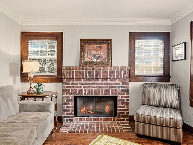Den with wood-burning fireplace