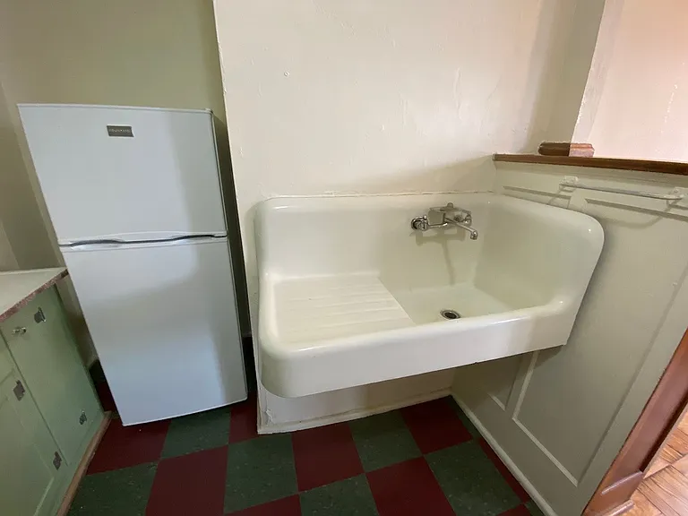 The original cast-iron sink adds timeless character and durability, blending historic charm with functionality.