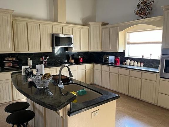 Fully equipped kitchen with wall oven.