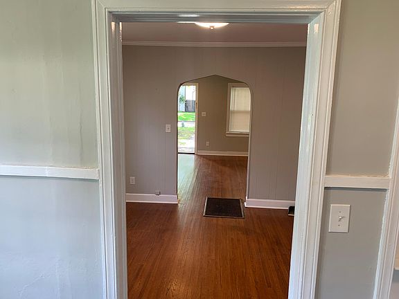 Hardwood floors with traditional archways