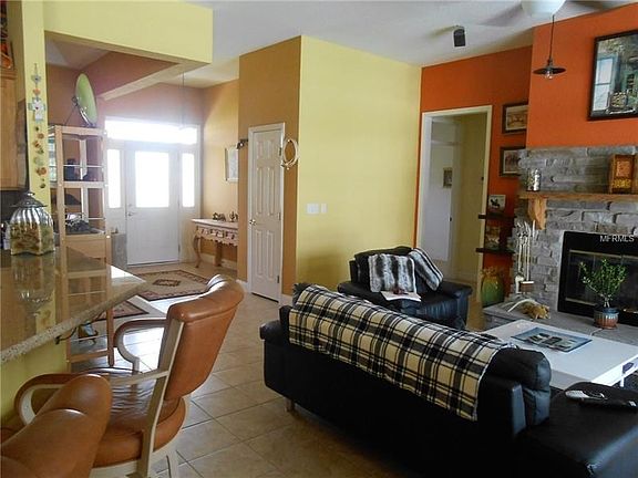 View from the kitchen of the front entry and doorway, leading to bedrooms 2 & 3, and a hall bath with shower and tub.