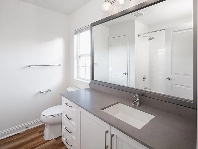 Bath with white cabinetry, grey quartz countertop, and hard surface flooring